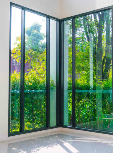 Glass window overlooking green garden